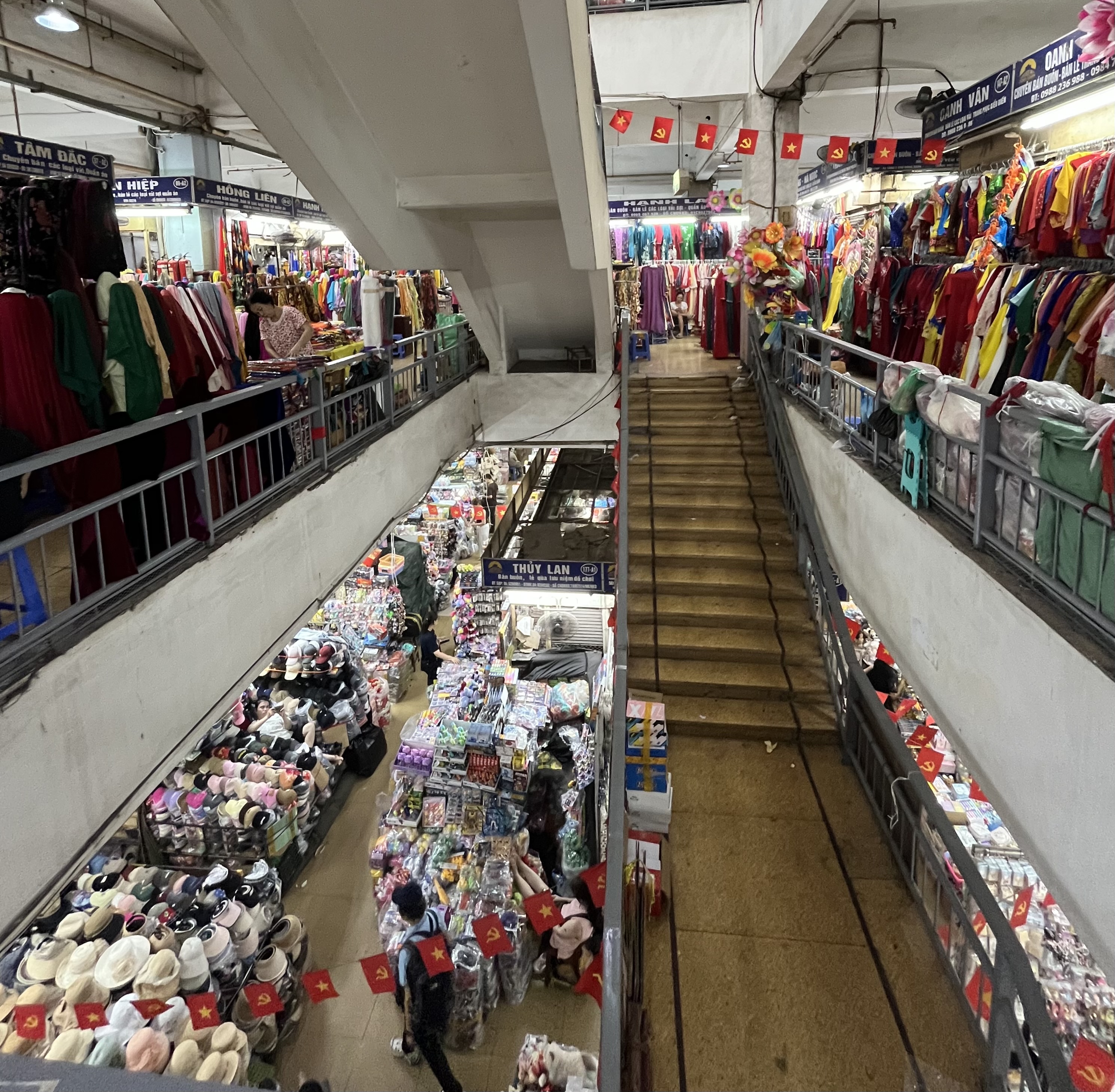 Sourcing sustainable jewellery materials at the busy Đồng Xuân fabric market in Hanoi, Vietnam.